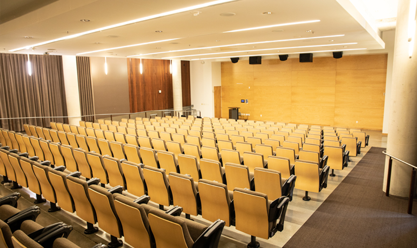 A large lecture hall with many chairs.