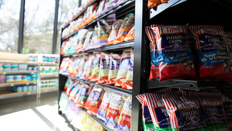 Shelves stocked with chips in District Market Oak.