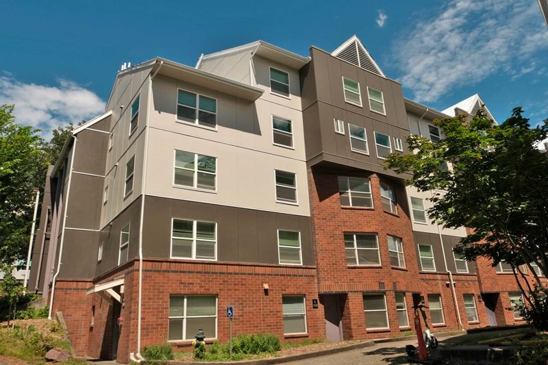 A white, brown, and brick building.