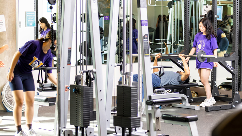 Students using exercise equipment in Fitness Center West.