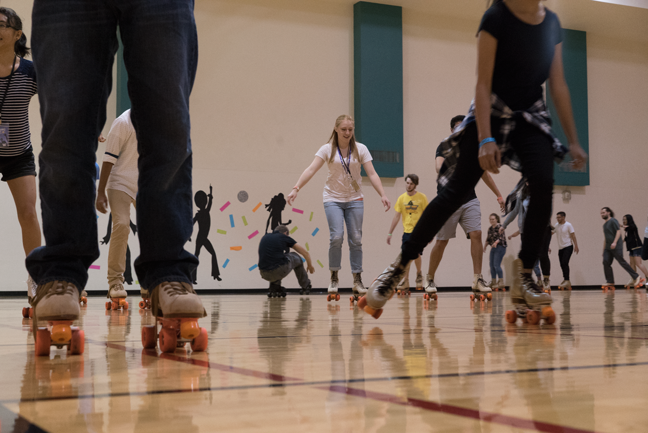 Students rolling skating in a gym