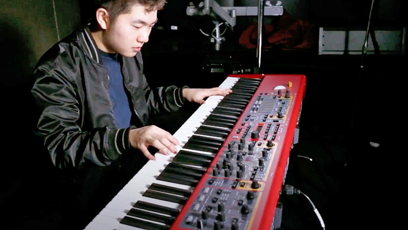 A student playing piano in the Sound Lab