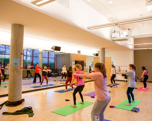 Students exercise in Fitness Center West workout class