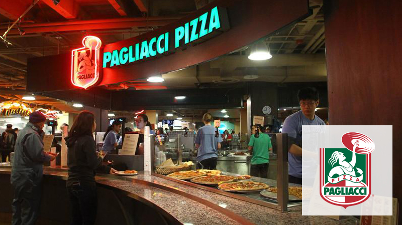 Students ordering pizza from workers at Pagliacci Pizza in Husky Den.