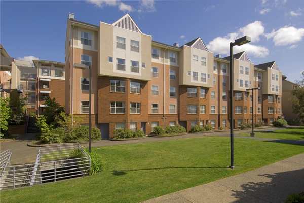 A brown building with a lawn.