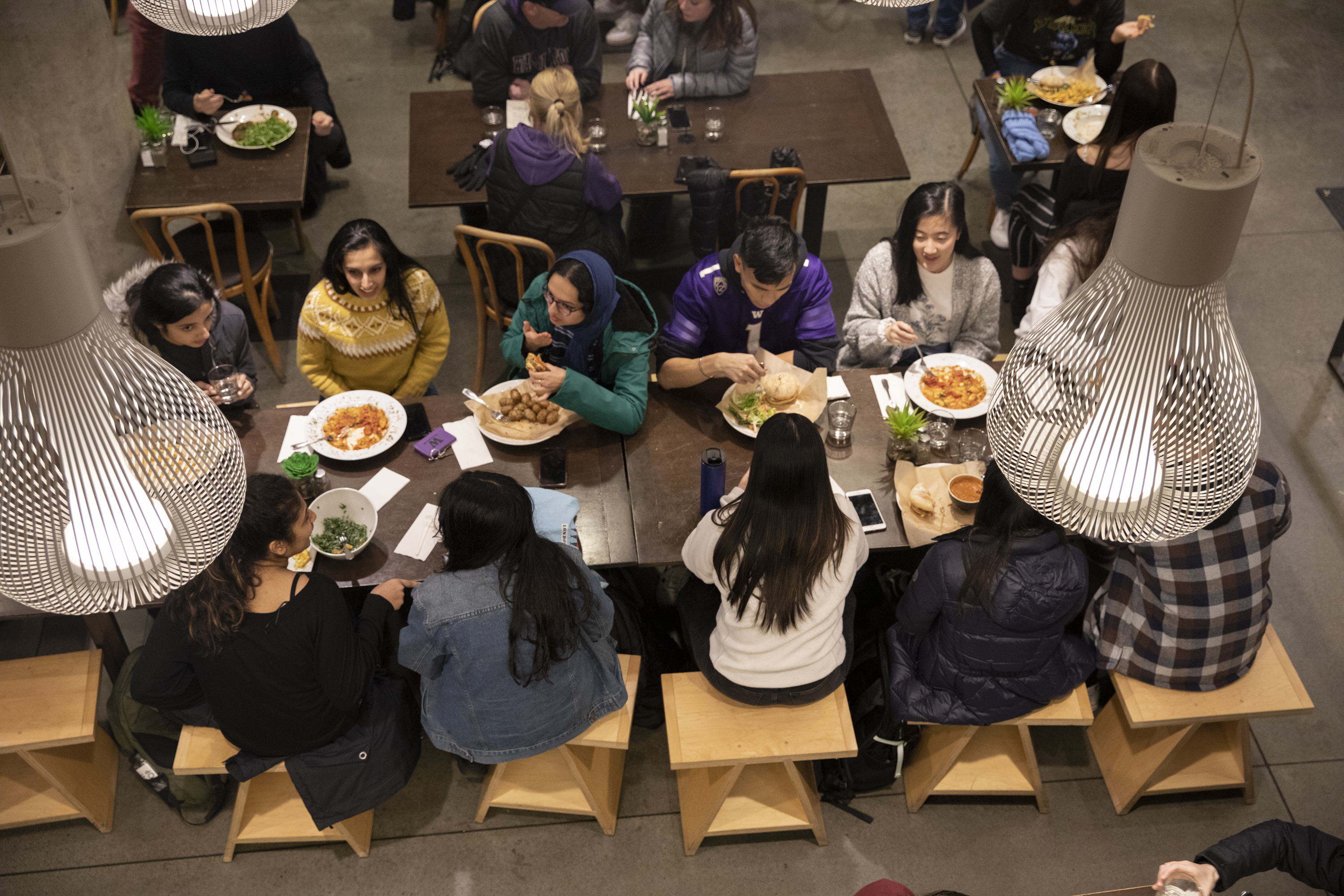 Students eat at table in Cultivate