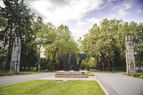 Bronze W on tree lined street.