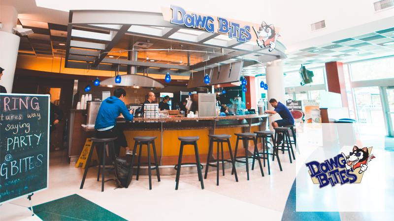 Students sitting on stools at Dawg Bites in the IMA.