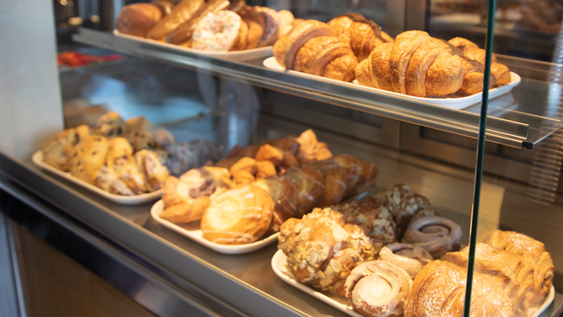 Pastries in a glass case at Husky Grind, Denny Café.