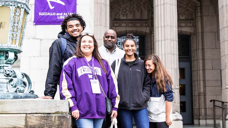 A family standing in front of Suzzallo Library.