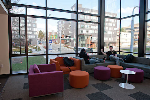 Two students talking in a residence hall lounge