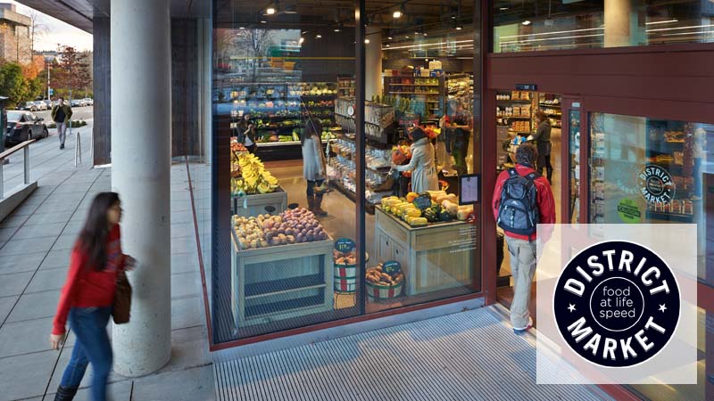 Students walking through the doors of District Market Alder.
