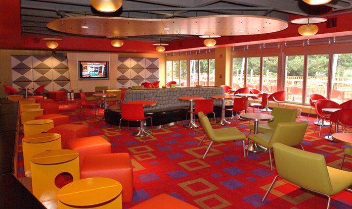 A colorful sitting room with tables and chairs.