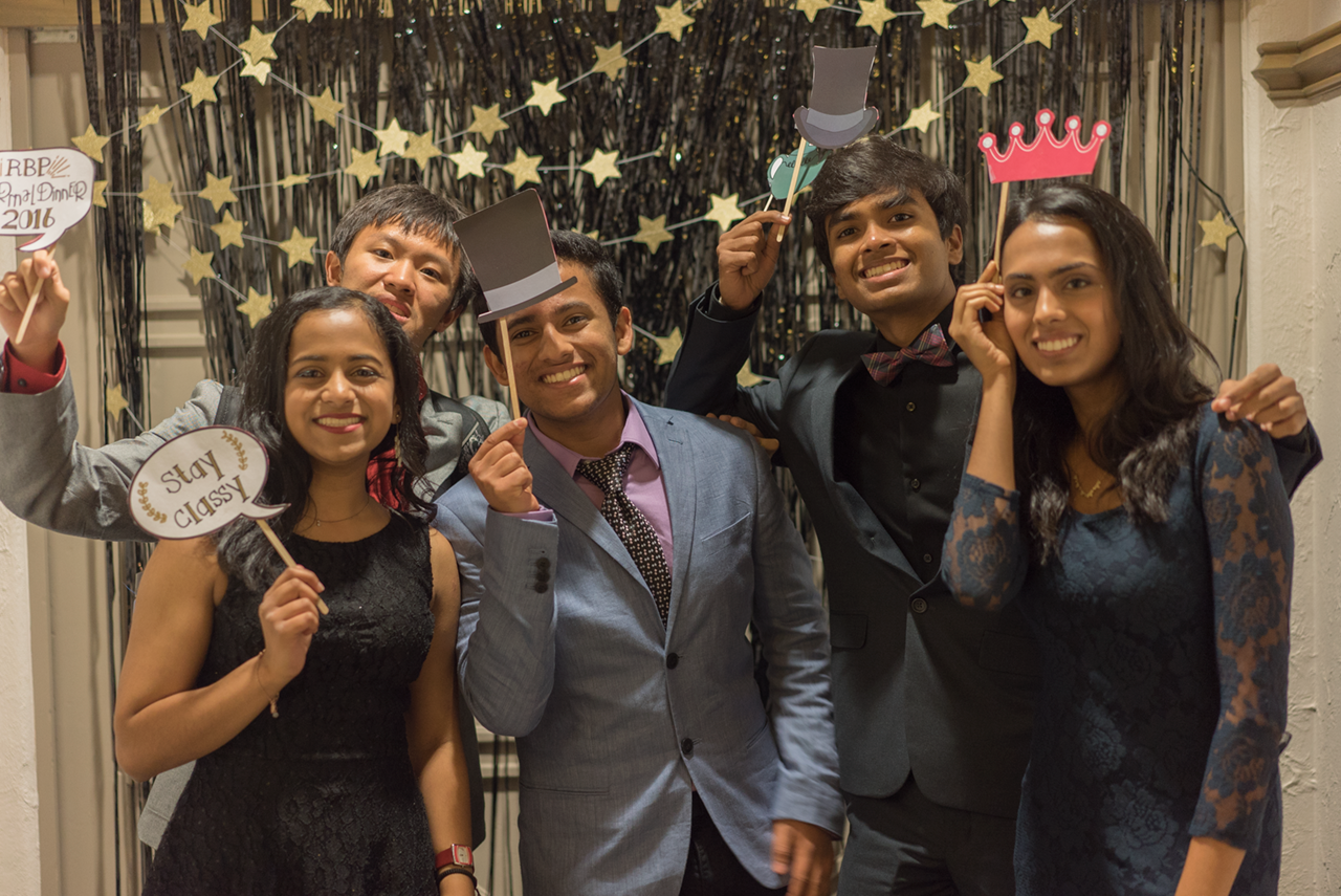 students smile at a photo booth