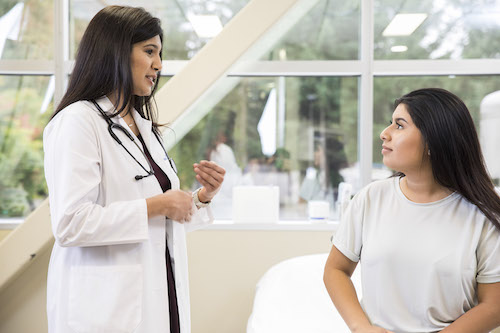 A student listens to a medical professional.