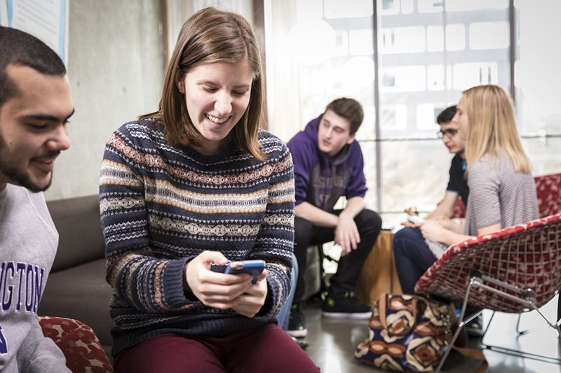 A group of students smiling and sitting.