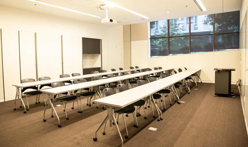 A room with desks, chairs, and podium.