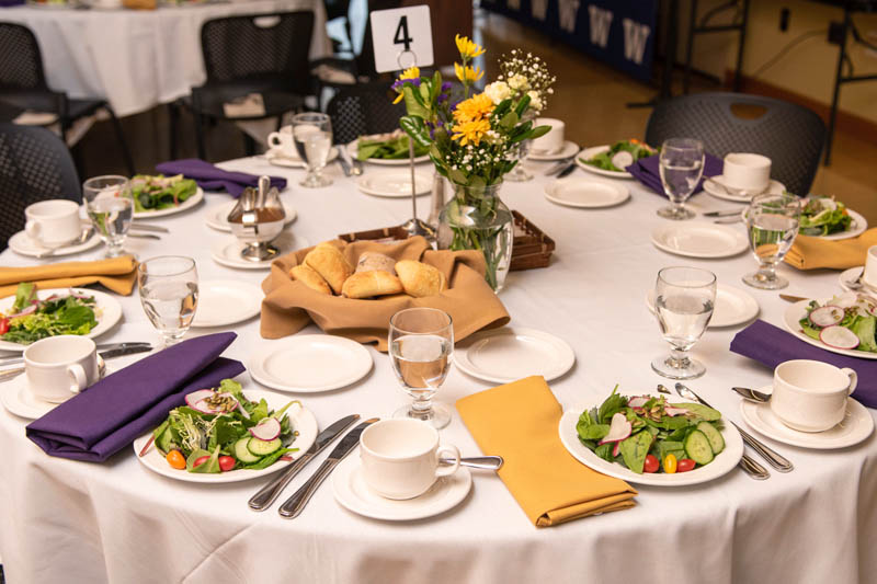 A set table with salads and bread.