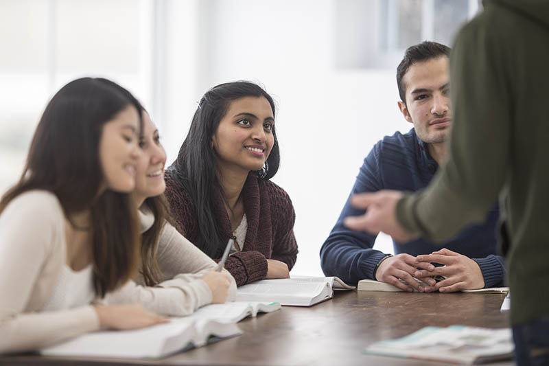 A group of students listening to a lecturer.