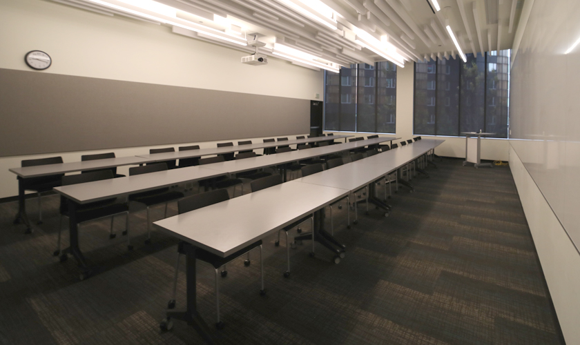 A large room with desks and chairs.