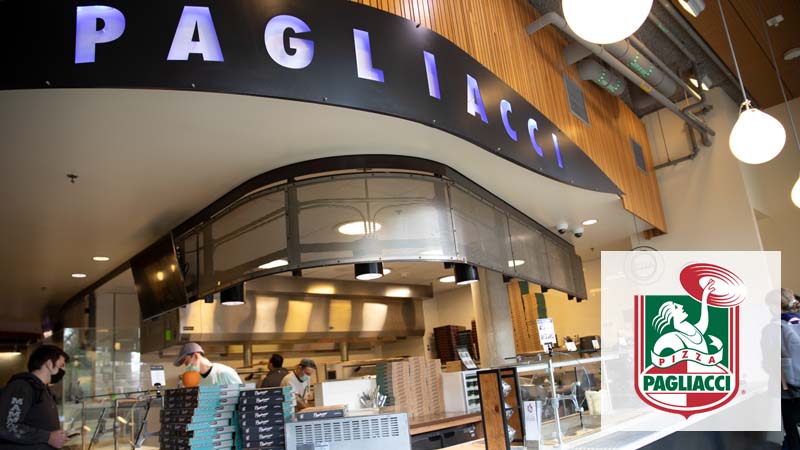 A student ordering from a worker at Pagliacci Pizza in Local Point.