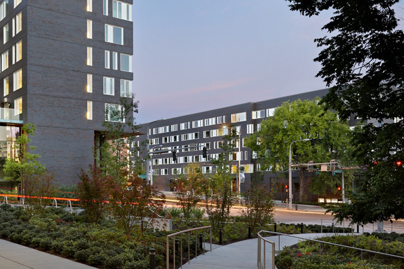 A gray building surrounded by trees.