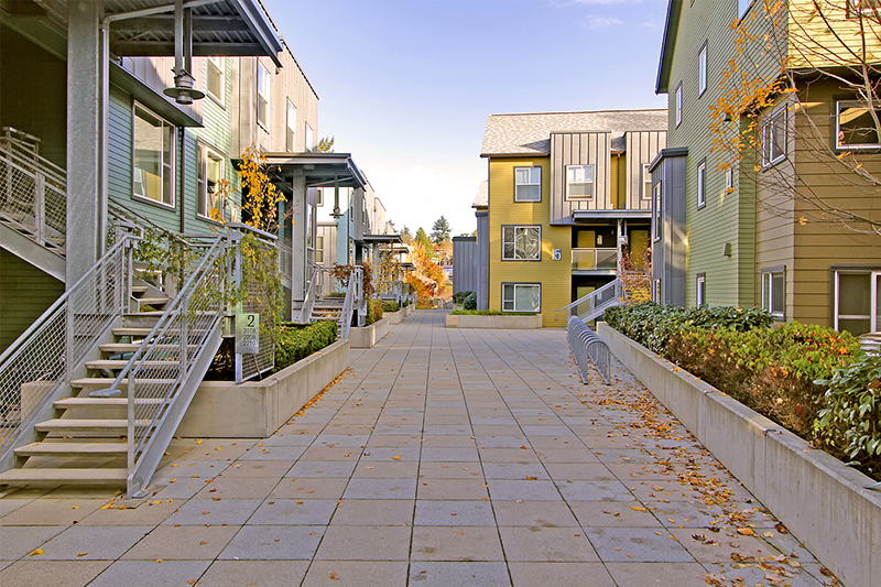 Yellow and green buildings with staircases.