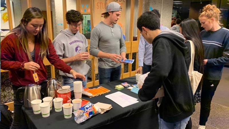 Students serving drinks