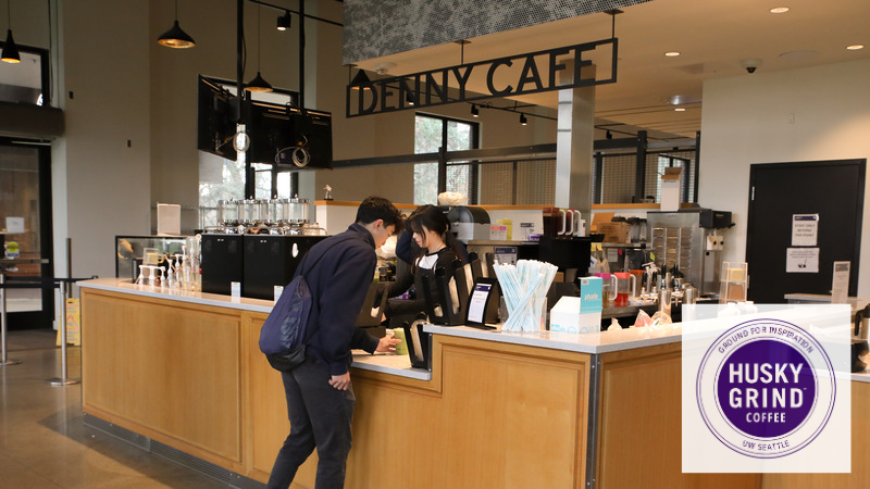 A student grabbing his drink from the counter at Husky Grind, Denny Cafe.