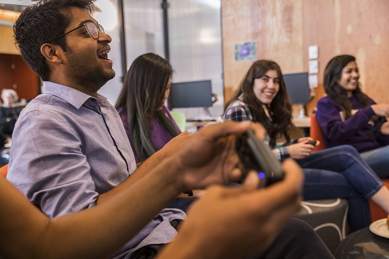 A group of students playing video games in Area 01.