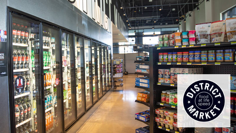 Shelves stocked with food and drinks in District Market Oak.