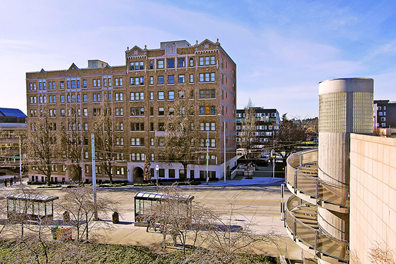 A brick building in front of a street.