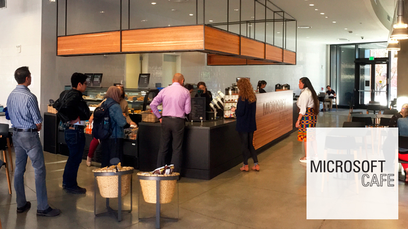 A group of people waiting in line to order at Microsoft Cafe.