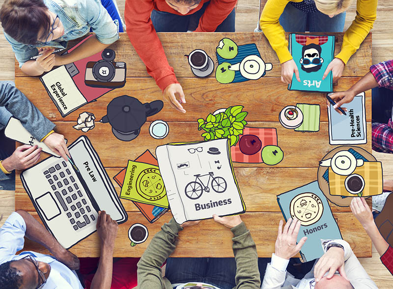 Students sitting around a table working on their interests