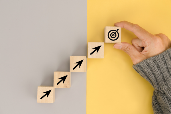 Image of hand moving goal blocks in upward trajectory