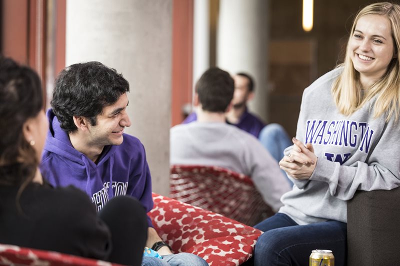 Students sitting on couches, smiling